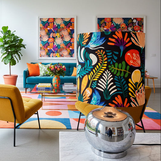 Lamp with a colorful floral patterned shade on a white surface.