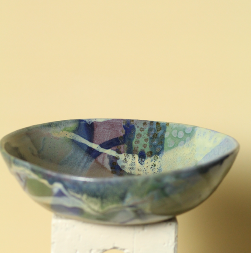 Ceramic bowl with abstract design on a beige background