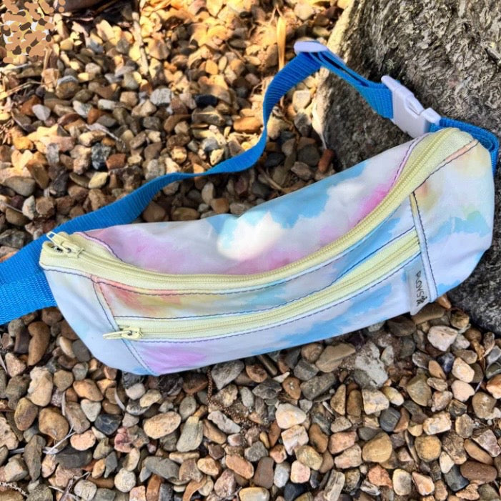 bum bag with tie-dye pattern on a rocky ground