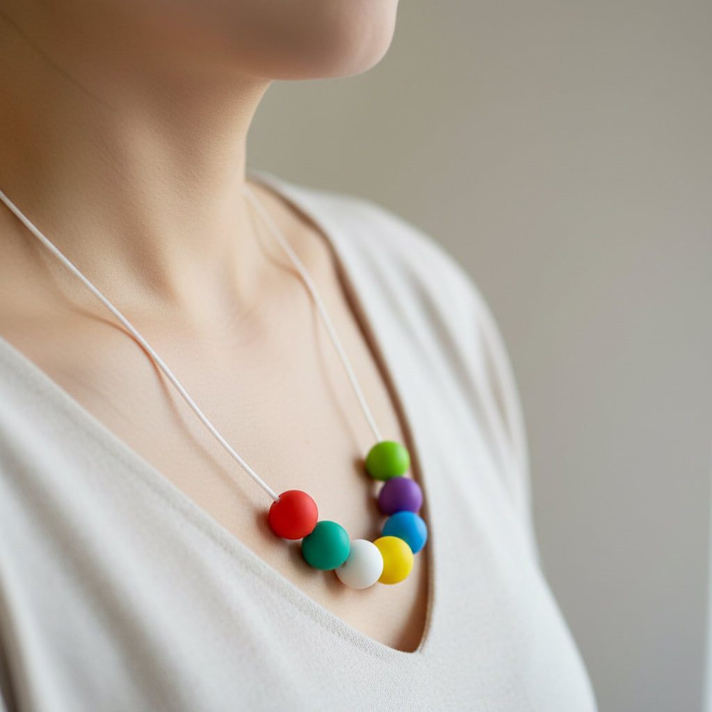 Necklace with colorful beads on a beige surface
