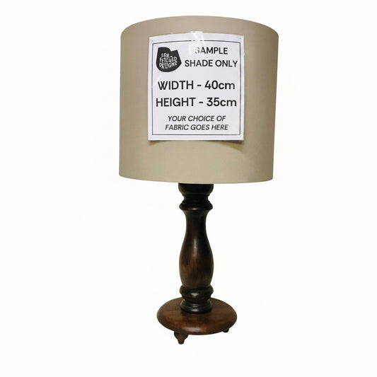 Lamp with wooden base and beige shade on a white background