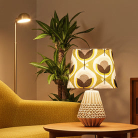Decorative lamp with a patterned shade on a white background
