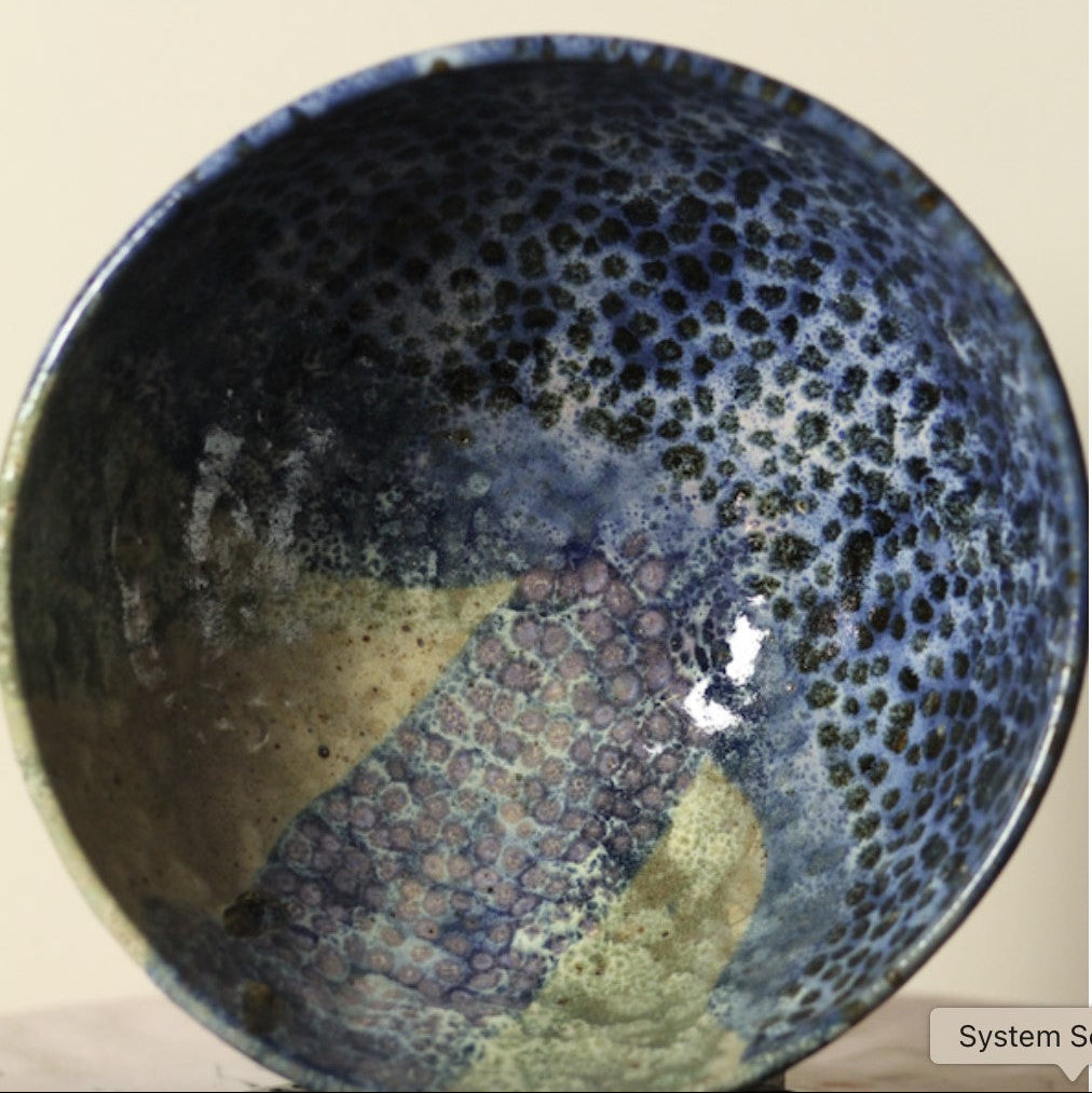 Ceramic bowl with textured surface on a beige background