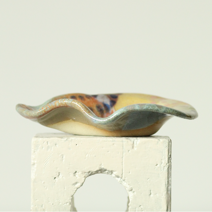 Ceramic dish with wavy edge on a light background