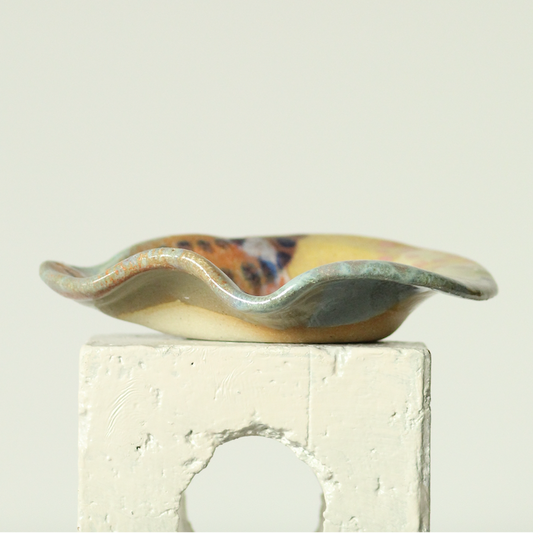 Ceramic dish with wavy edge on a light background