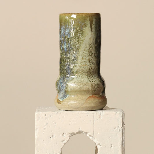 Ceramic vase with a textured surface on a beige background