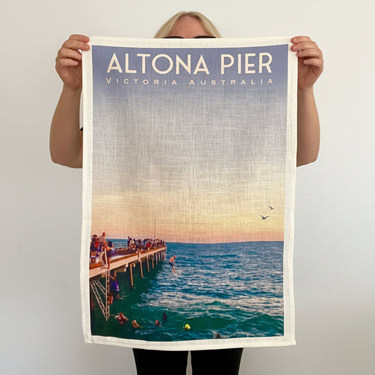 Person holding a towel with Altona Pier, Victoria, Australia design.