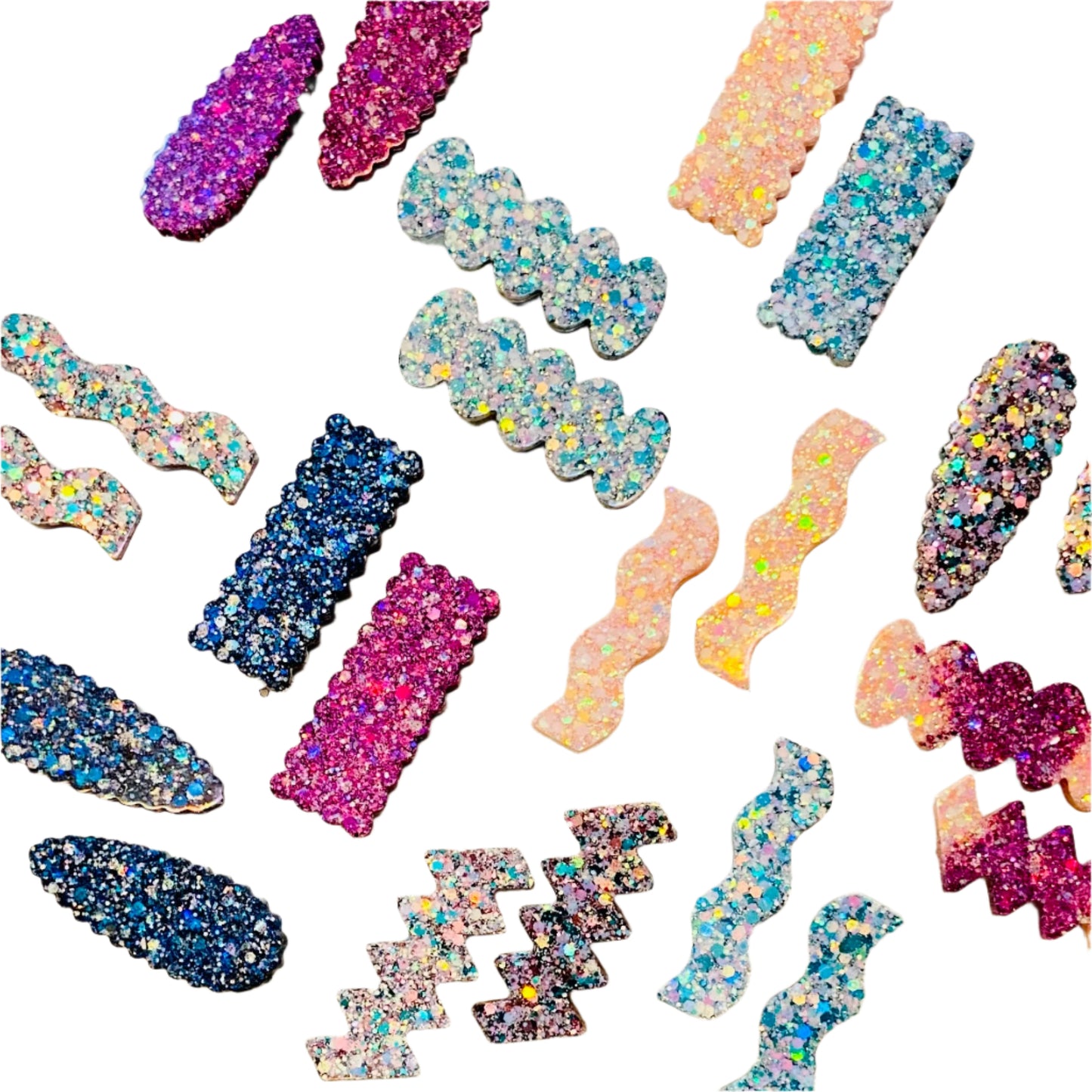 Colorful glittery hair clips on a white surface