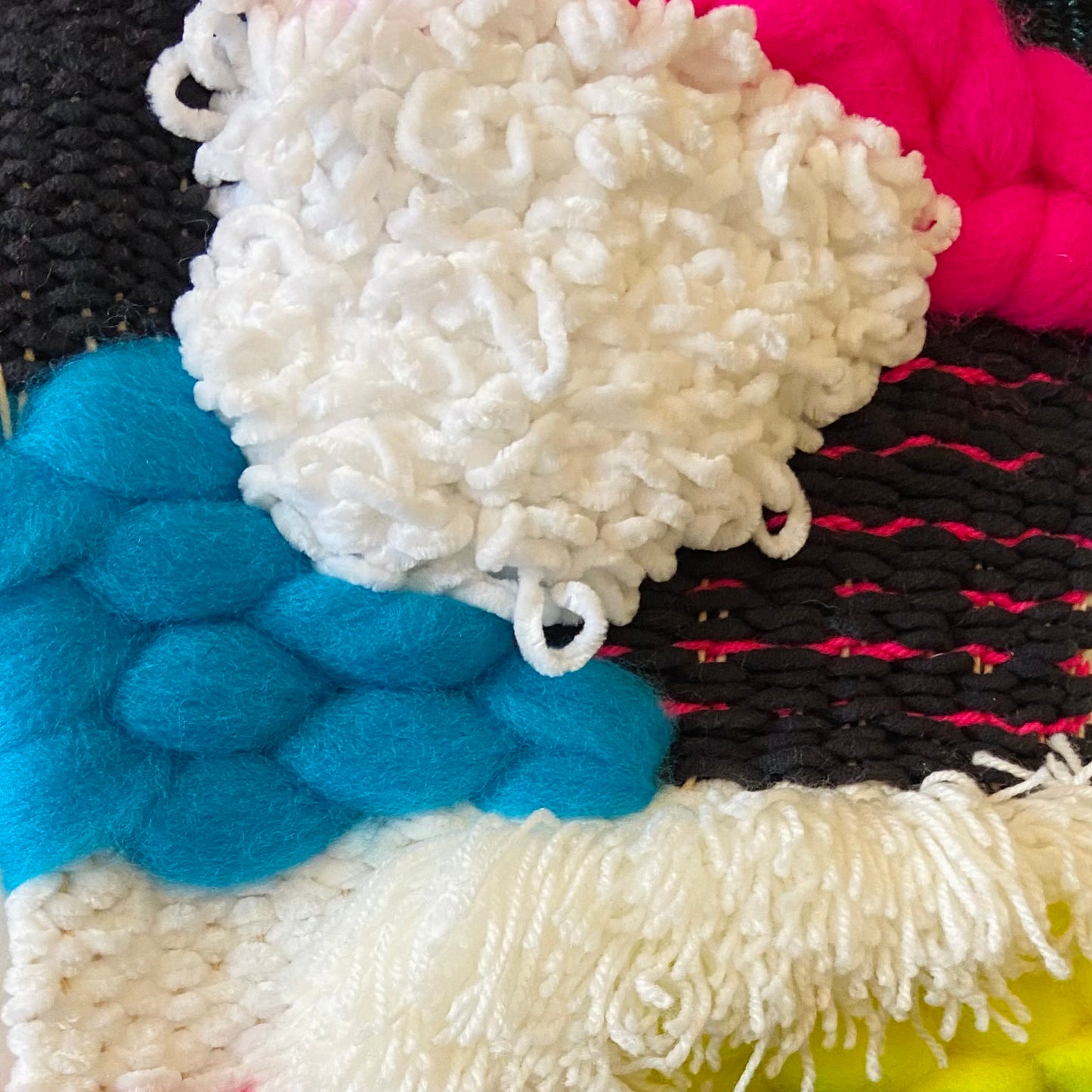 Close-up of various yarns in different colors and textures.
