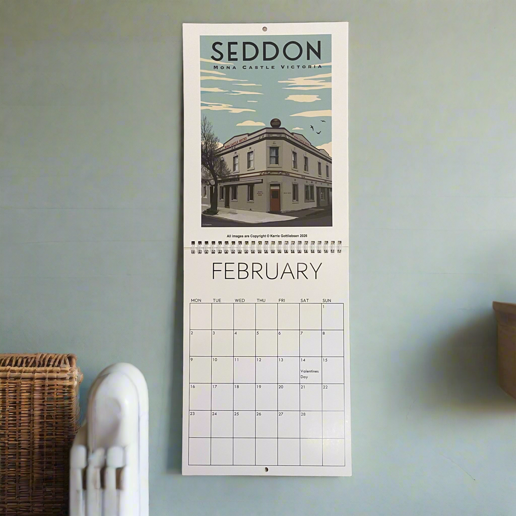 Wall calendar for February showing a building with 'SEDDON' at the top, on a light blue wall.