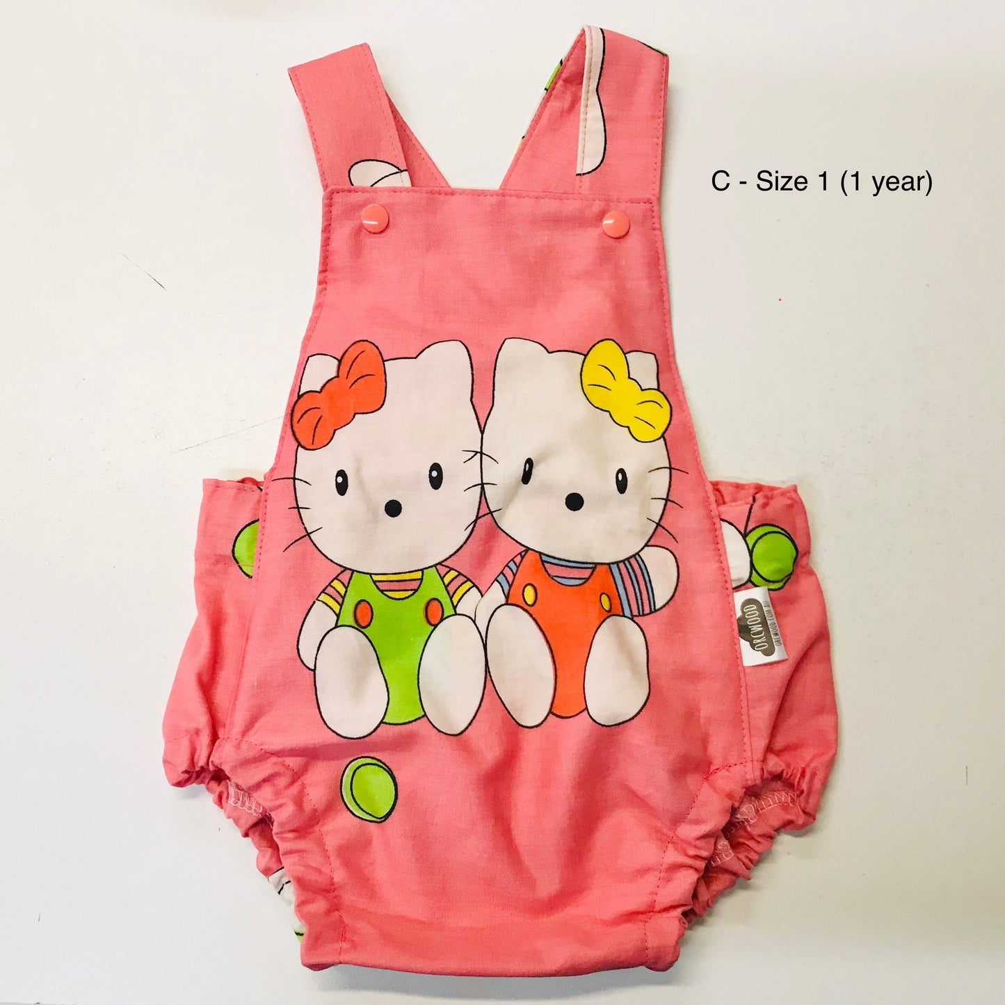Pink children's romper with cartoon characters on a white background