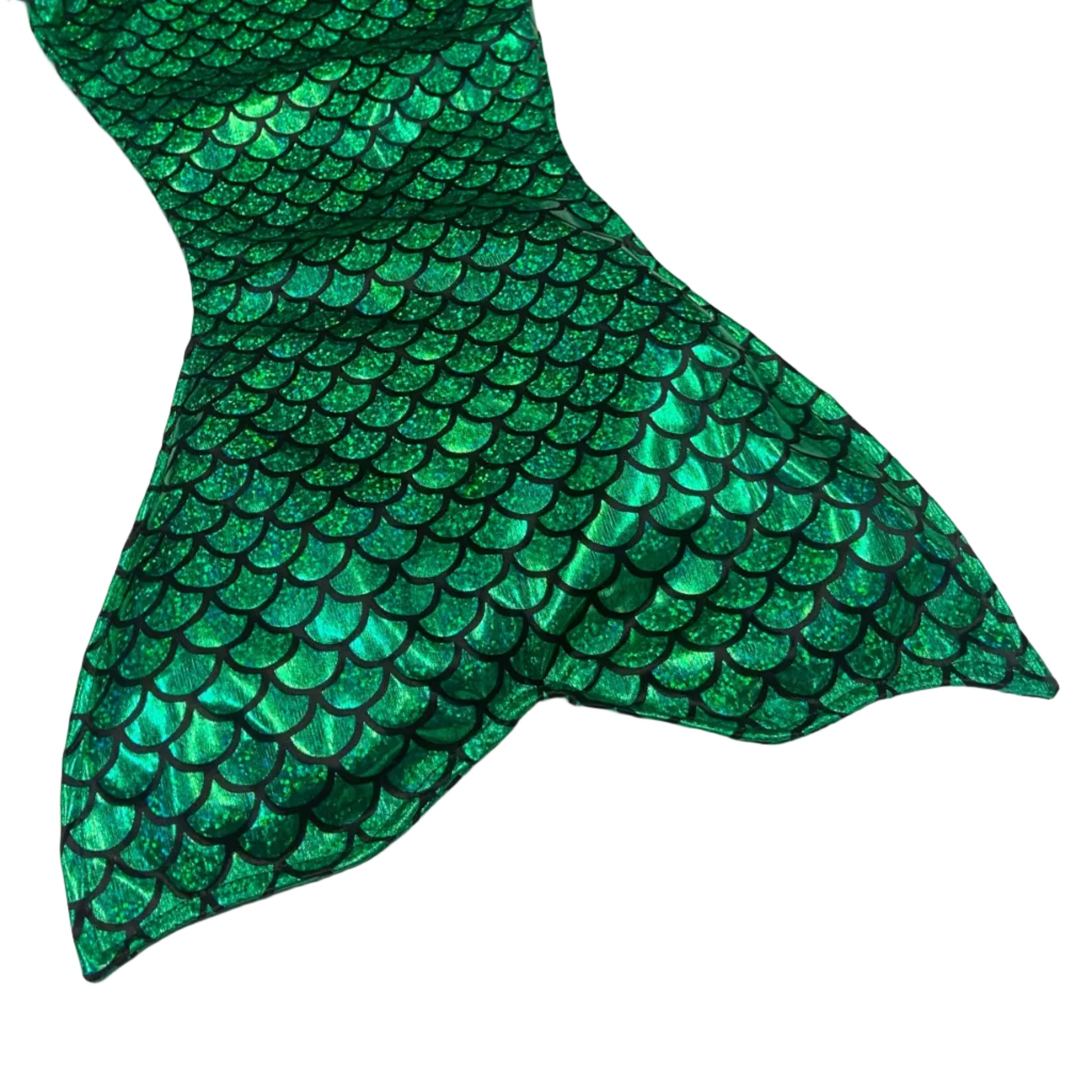 Green mermaid tail with fish-scale pattern on a white surface