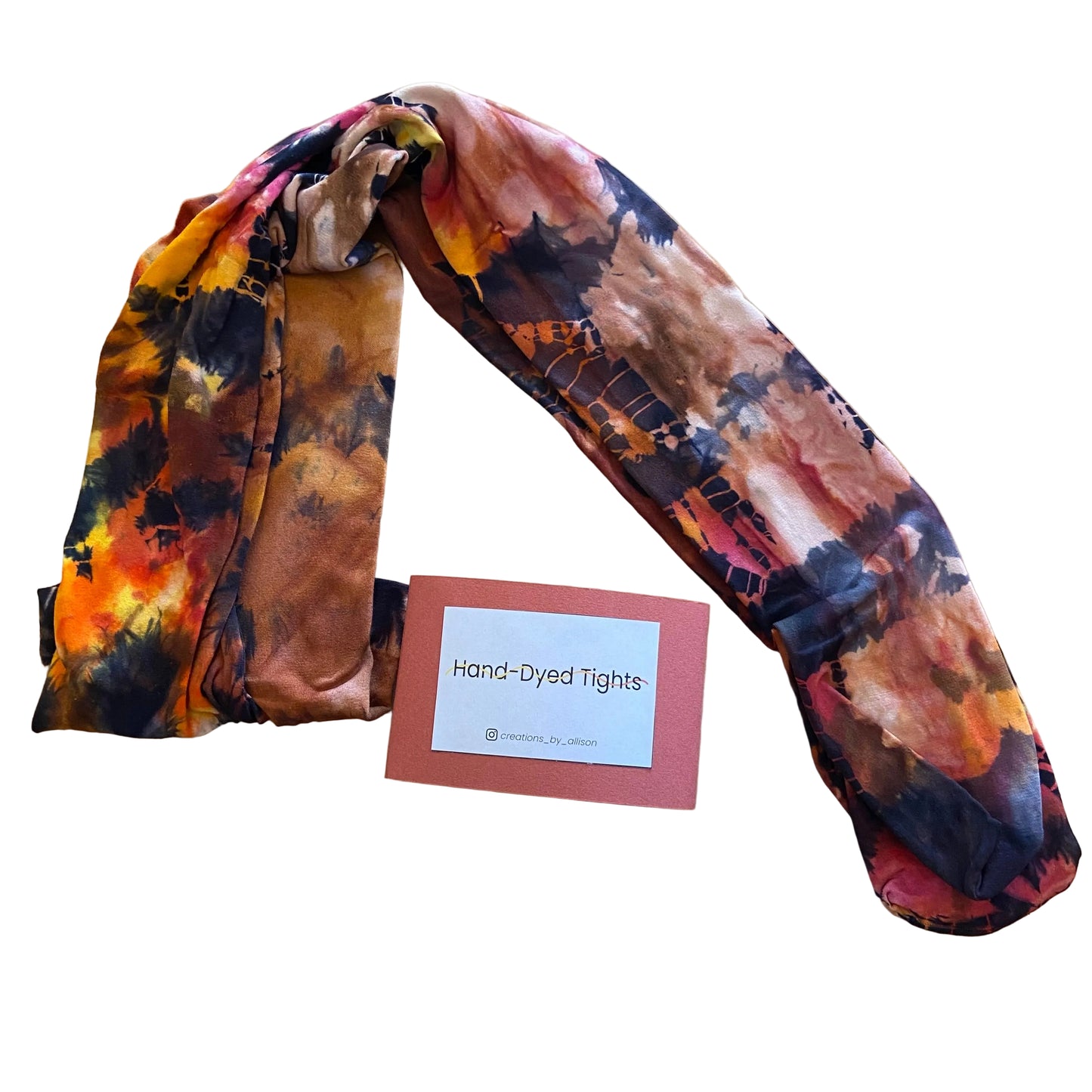 Hand-dyed tights with a label on a wooden surface