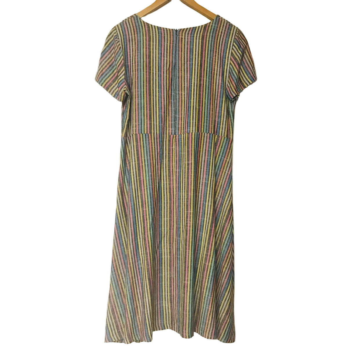 A short-sleeve A-line dress with a vertical multicolor stripe pattern, hanging on a wooden hanger against a plain off-white wall.