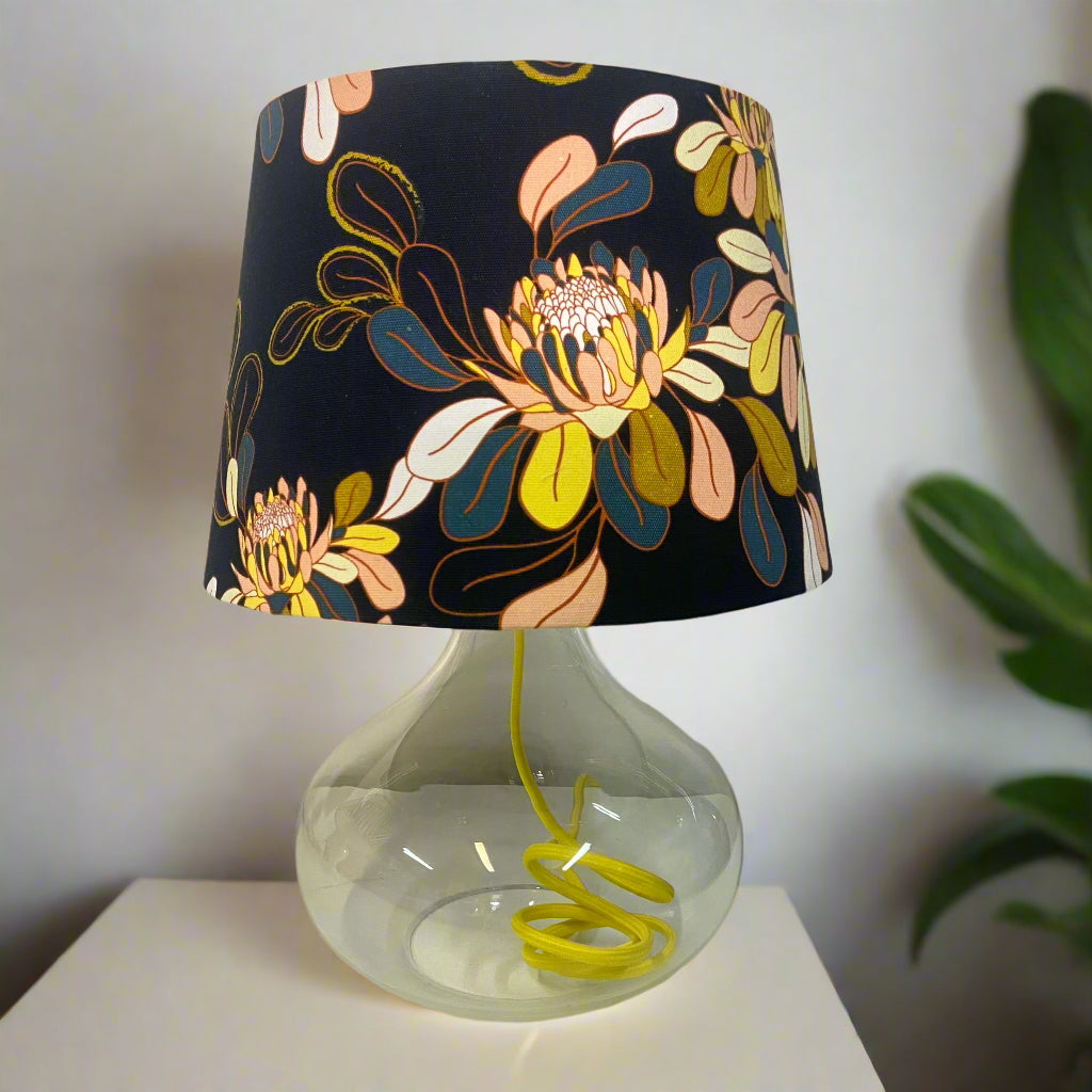 glass table Lamp with a floral-patterned shade on a white surface
