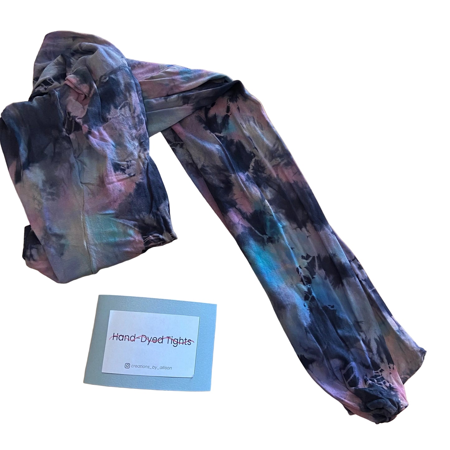 Hand-dyed tights with a label on a wooden surface