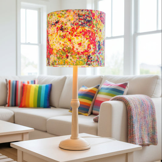 Lamp with a colorful floral patterned shade on a white background
