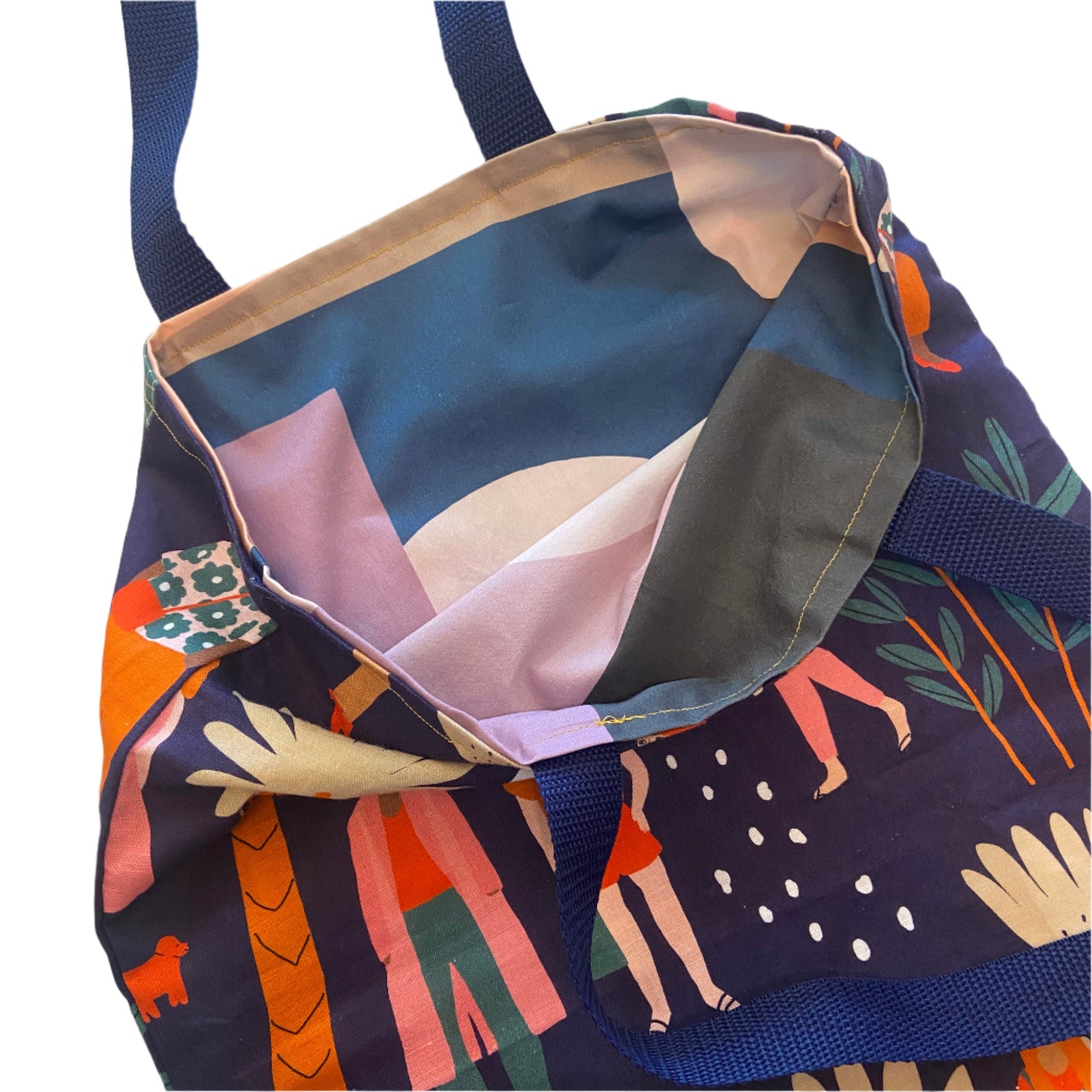 Colorful fabric with artistic designs and navy blue strap on a white background