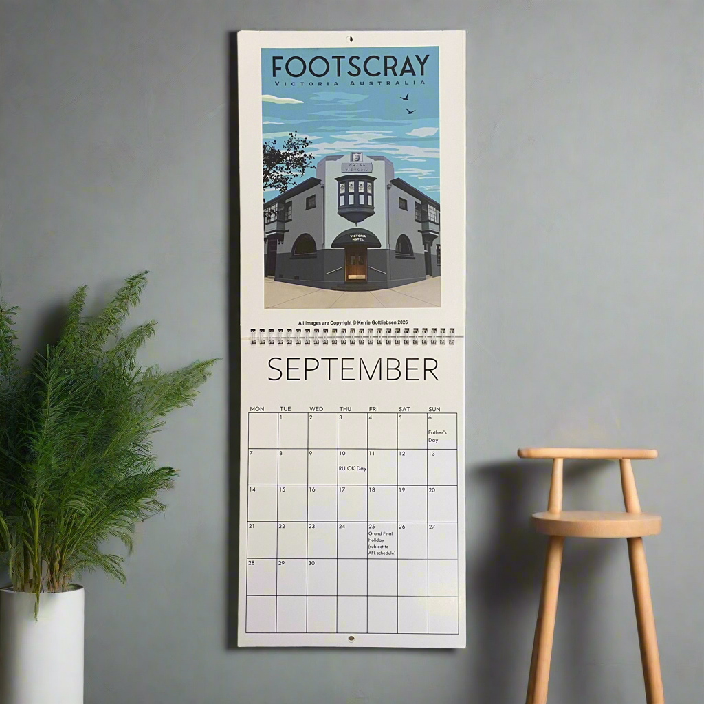 Calendar with a design of Footscray, Victoria, Australia on a gray wall with a plant and stool.
