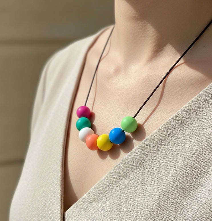 Necklace with colorful beads on a beige background