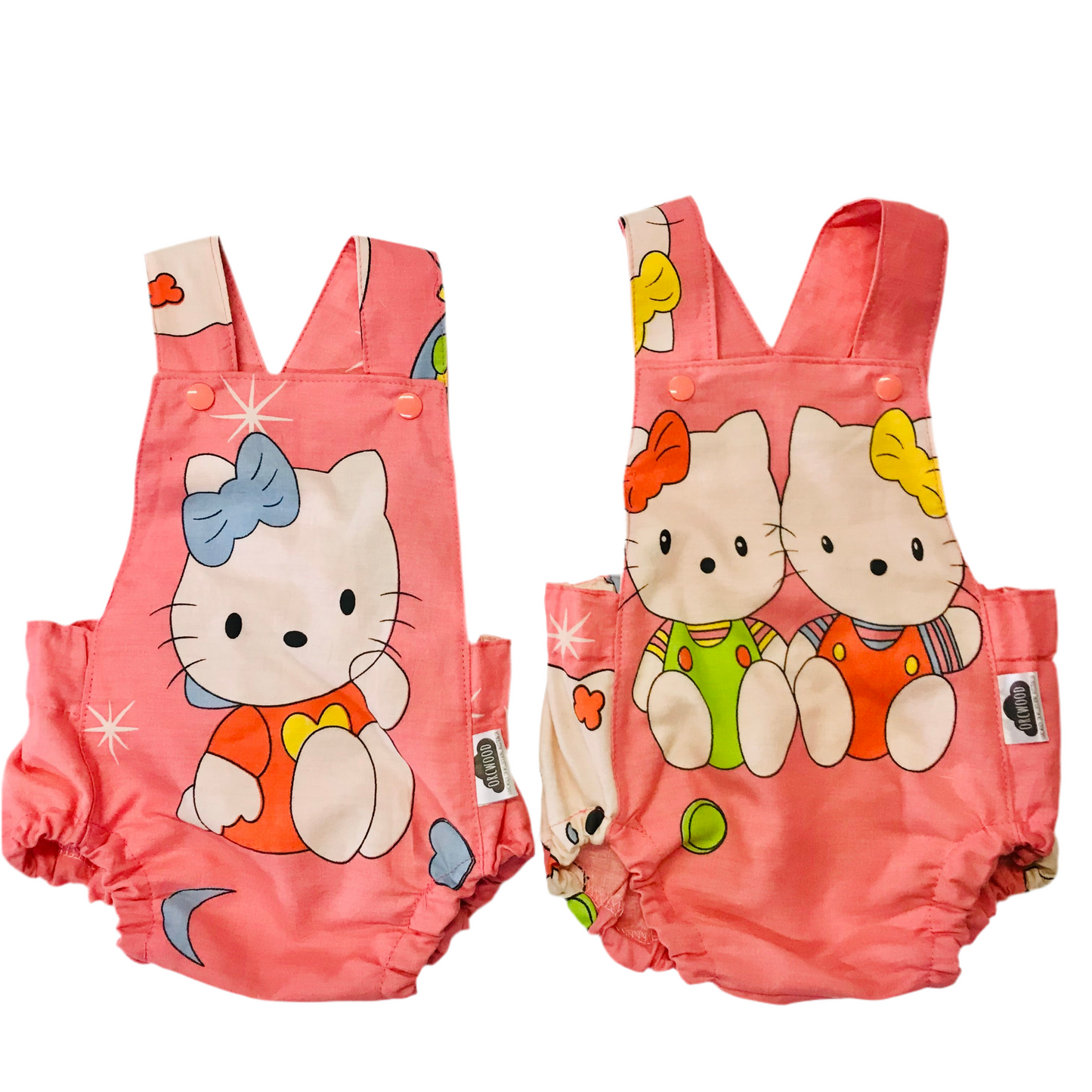 Pink baby summer romper with cartoon cat design on a white background