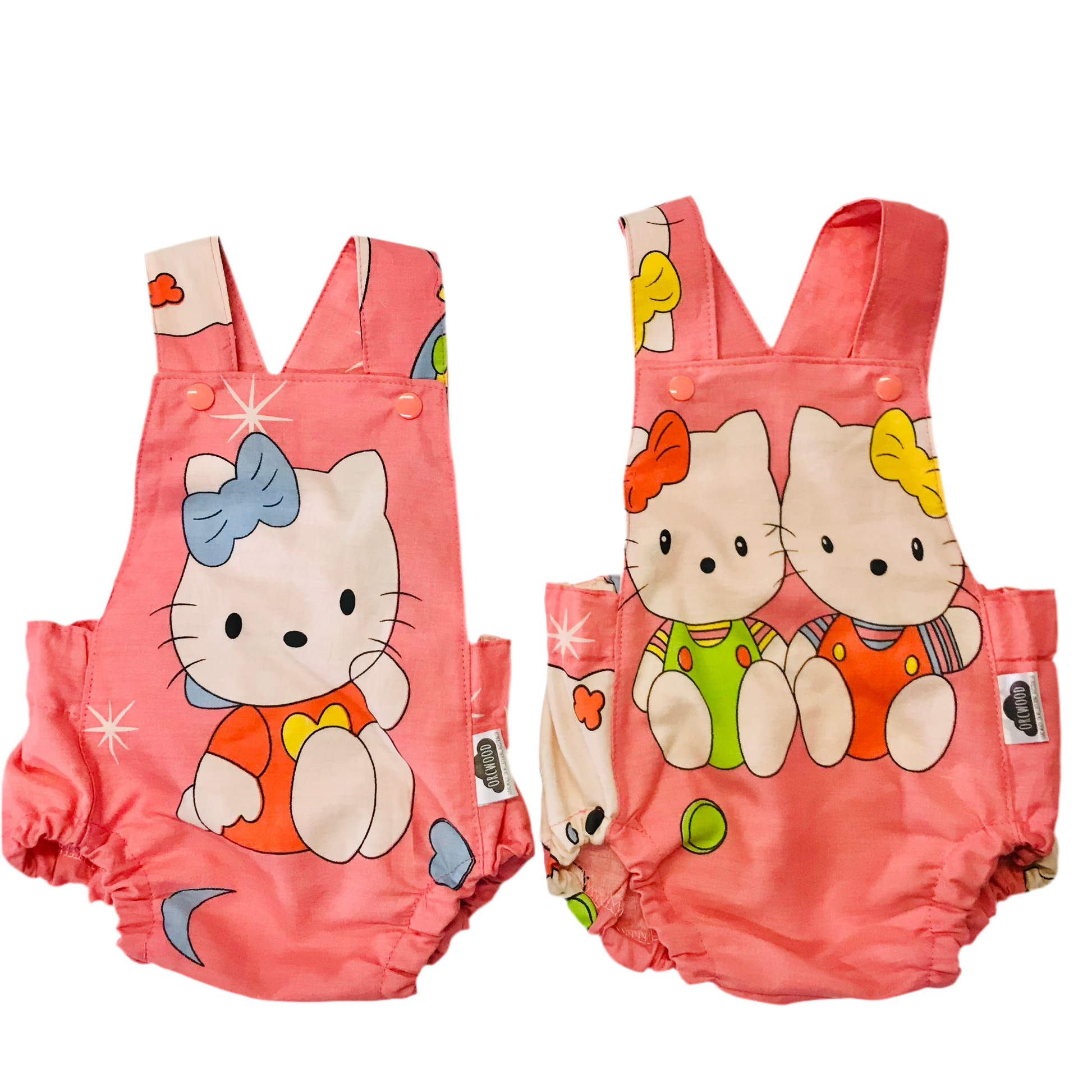 Pink baby summer romper with cartoon cat design on a white background