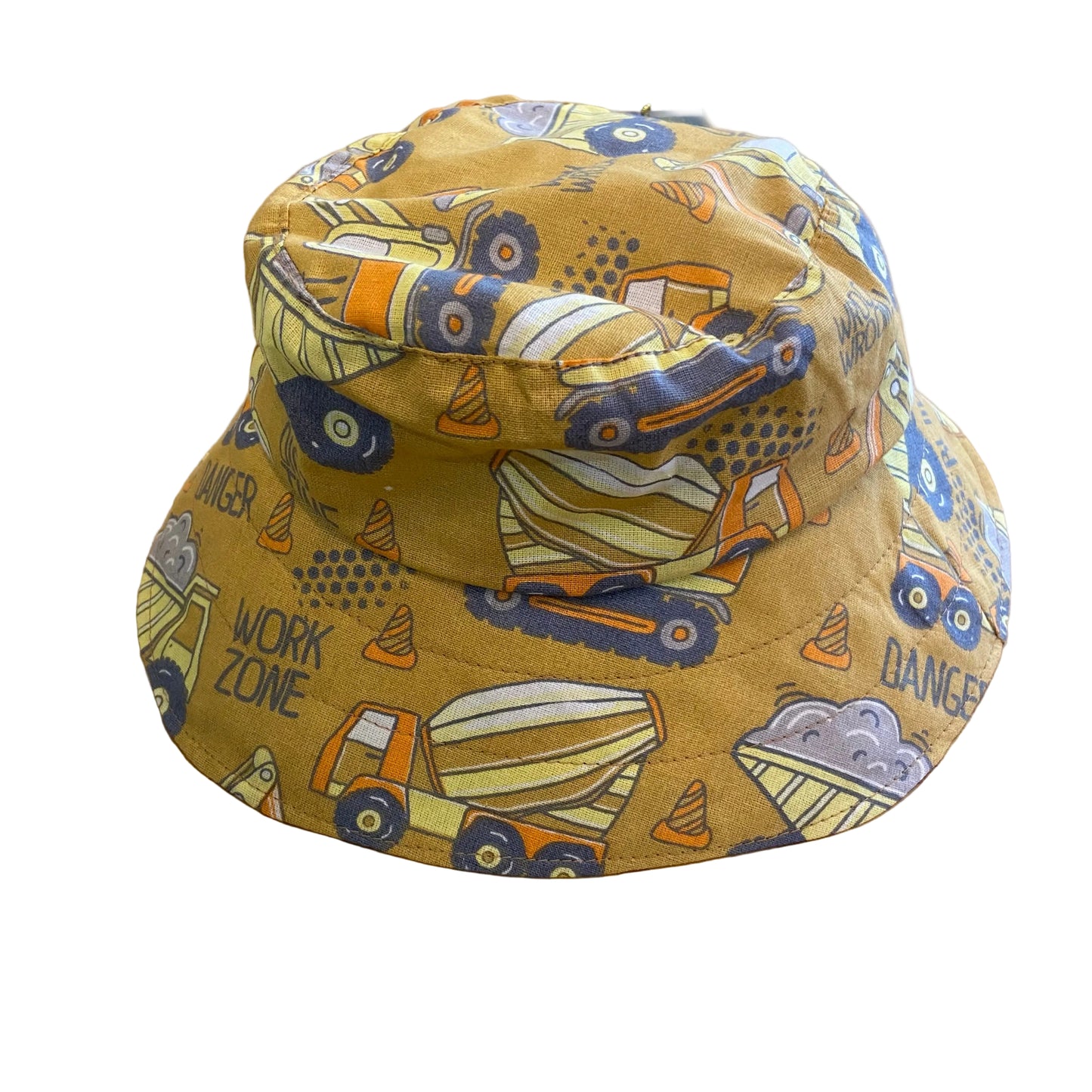Yellow bucket hat with construction vehicle pattern on a wooden surface