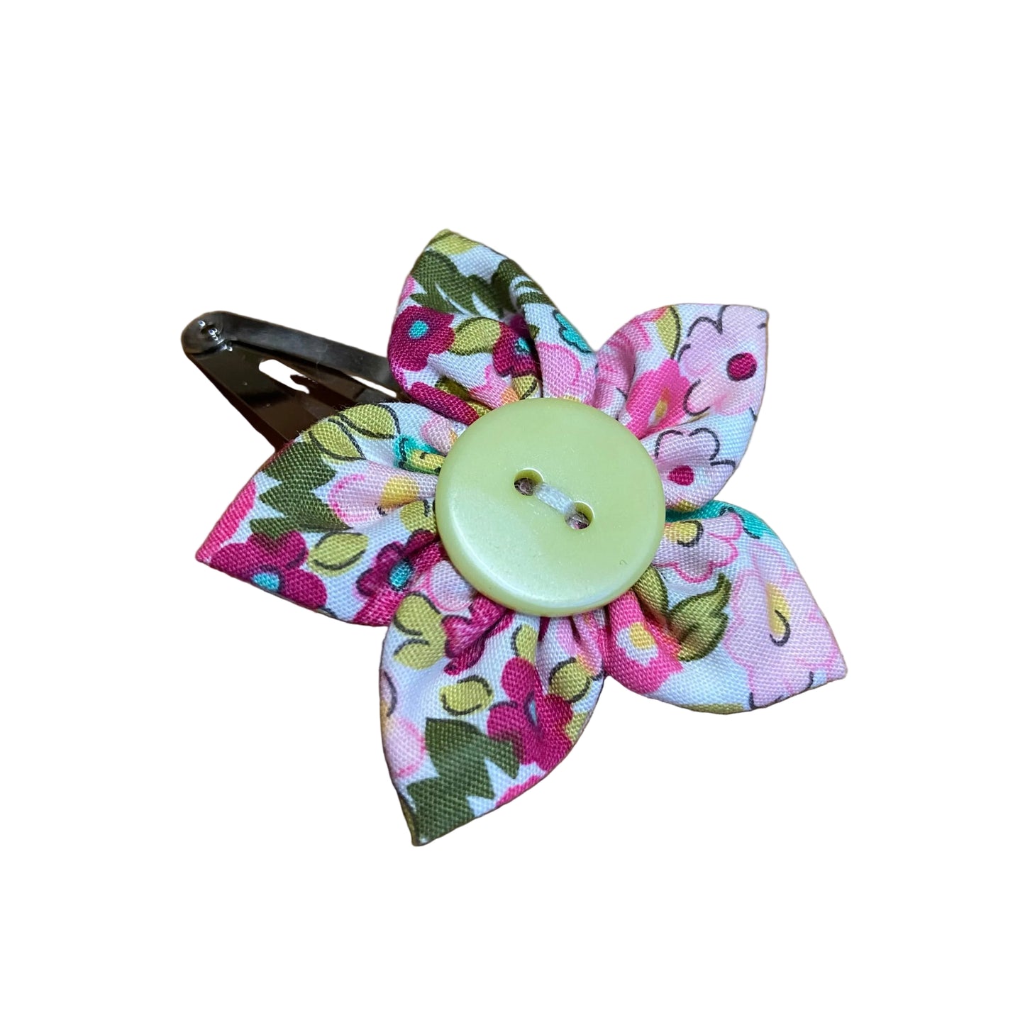 Floral fabric bow with a button center on a wooden surface