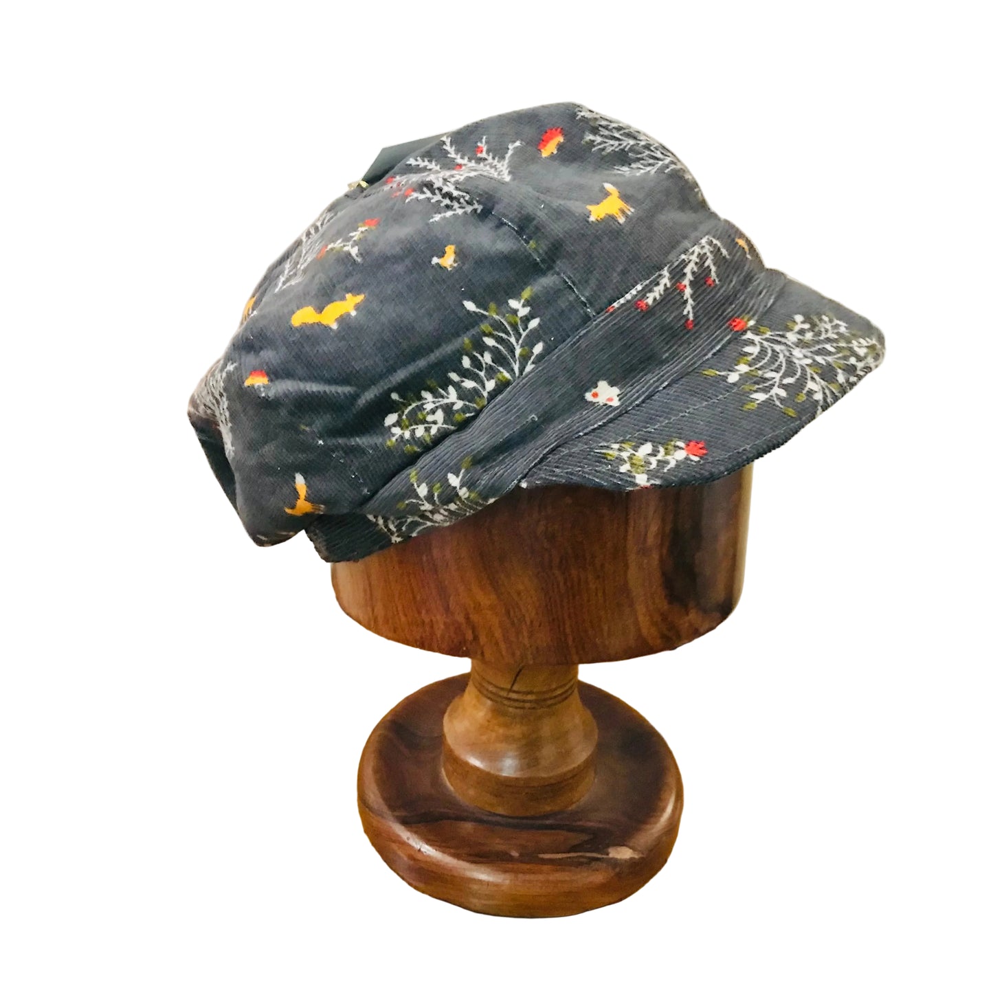 Floral-patterned bucket hat on a wooden mannequin head against a neutral background