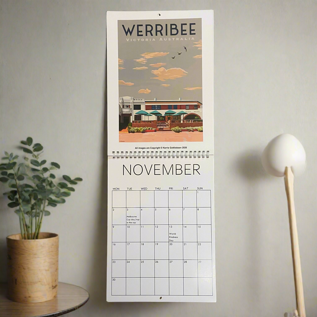 Calendar with Werribee, Victoria, Australia design on a wall next to a plant and lamp.