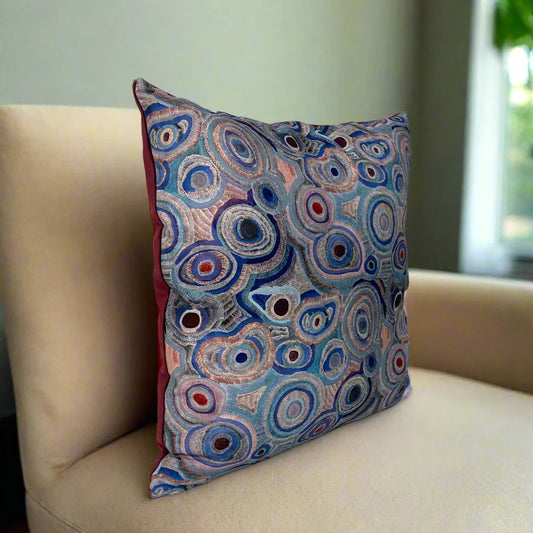 Decorative pillow with circular pattern  against a white background
