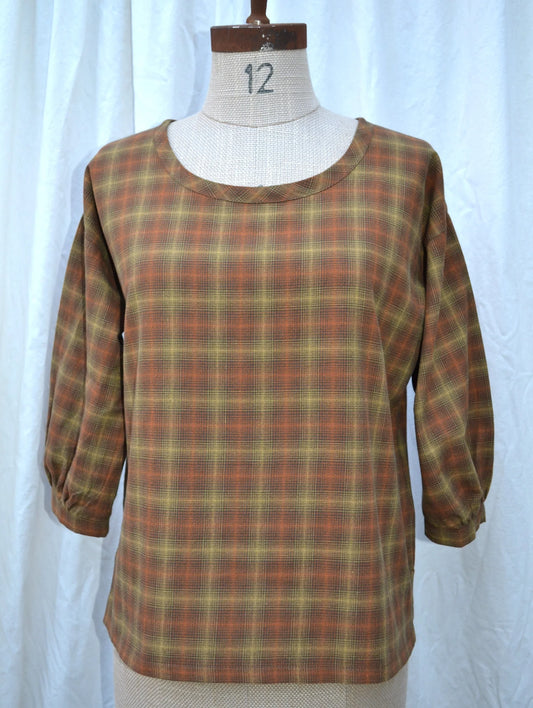 Plaid shirt on a mannequin against a white background