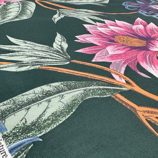Close-up of fabric with pink flower and green leaf pattern on a dark background