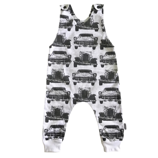 Children's overalls with vintage car pattern on a white background