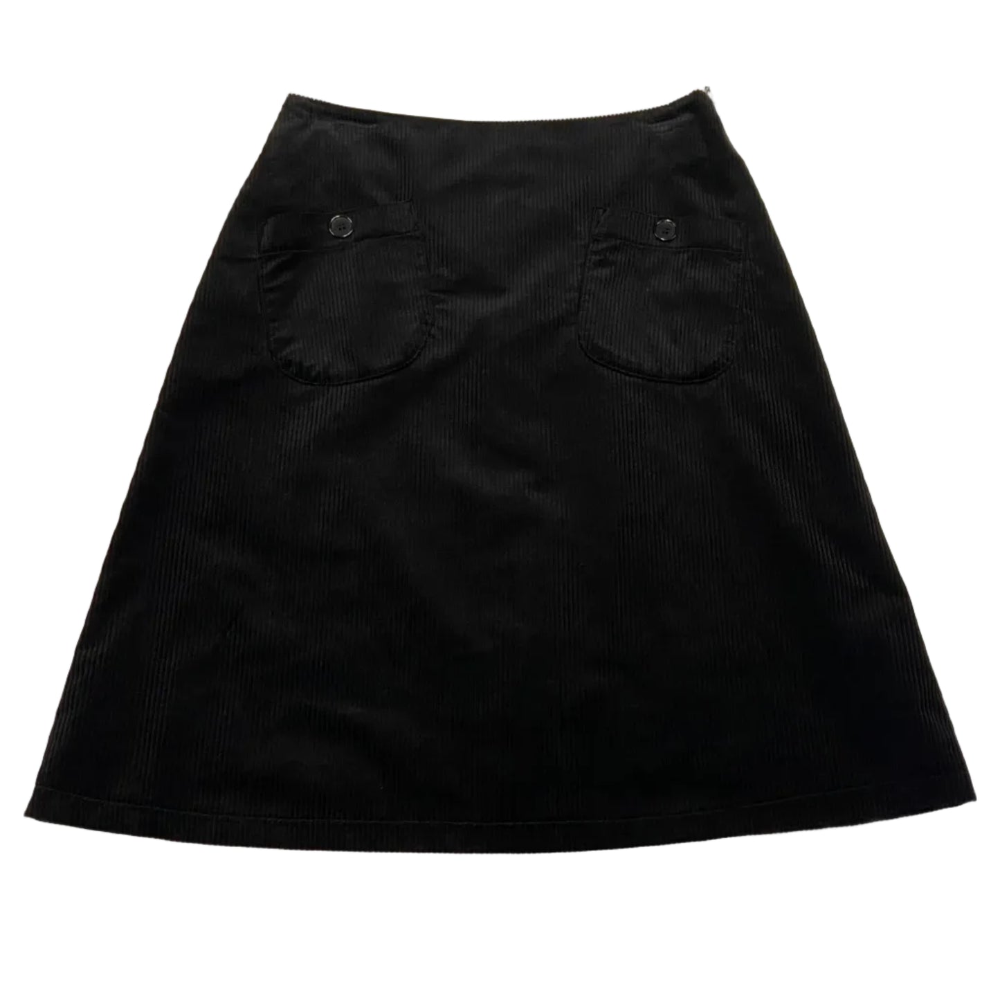 Black skirt on a white table with a pen and paper in the background
