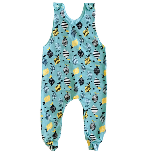 Children's handmade long romper  overalls with lemons and lime abstract pattern on a light blue background