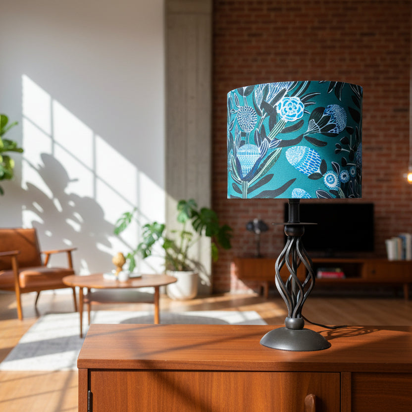 Table lamp with a decorative blue and green lampshade on a white surface.