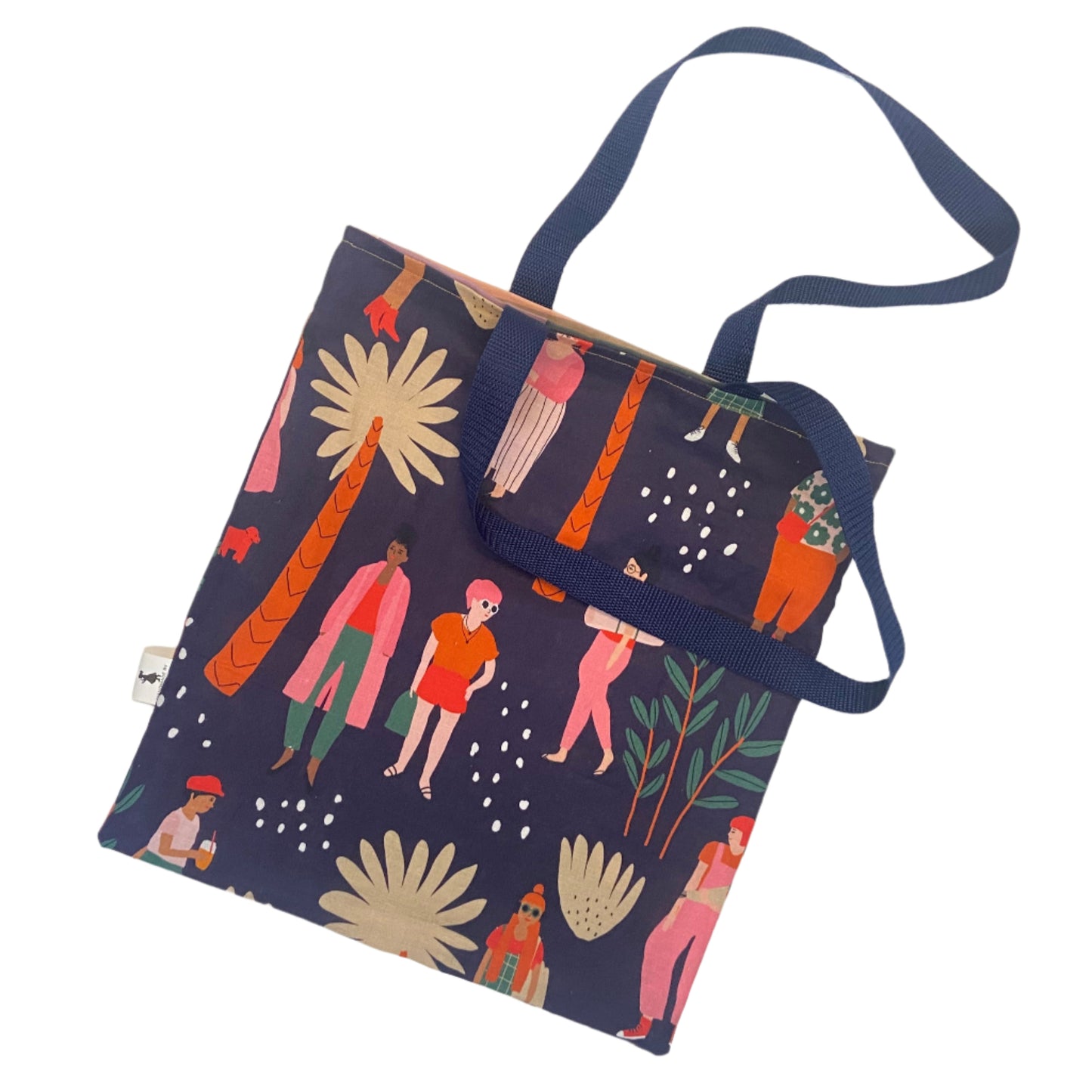 Colorful tote bag with artistic design on a white surface