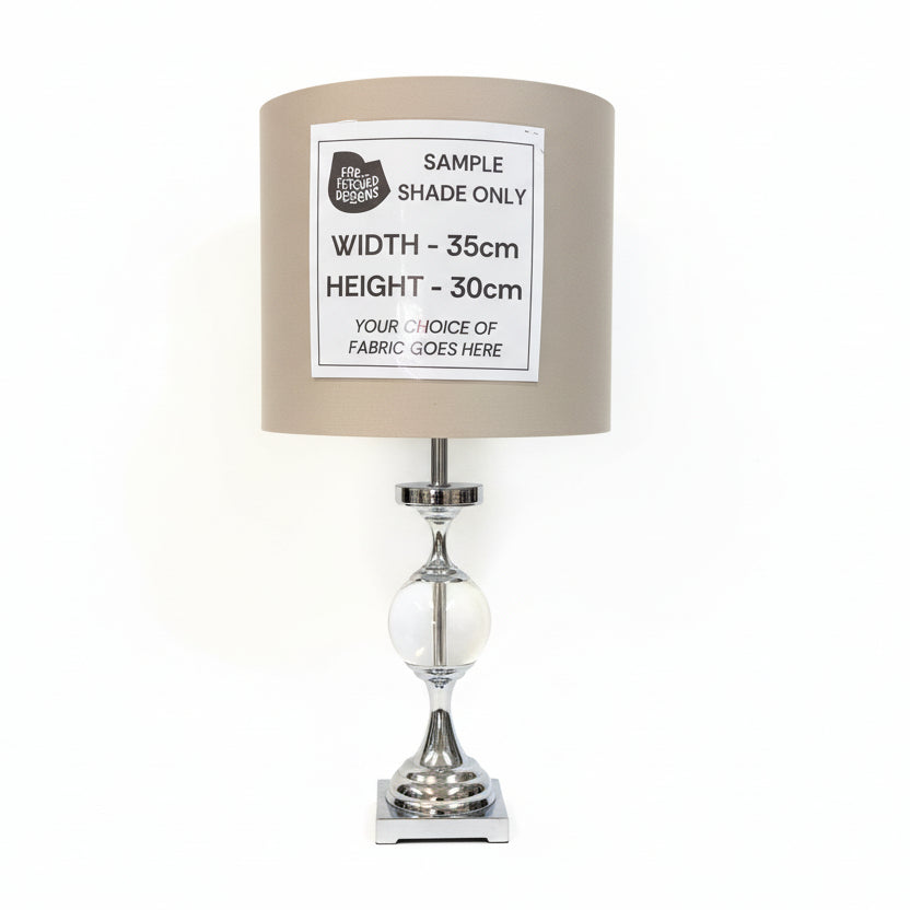 Lamp with a sample shade label on a white surface