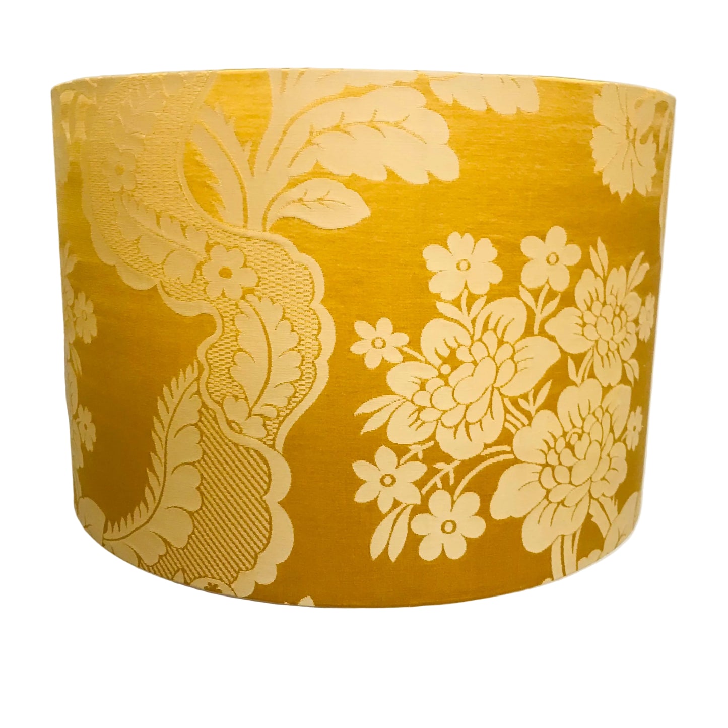 Yellow gold floral patterned lampshade on a white background