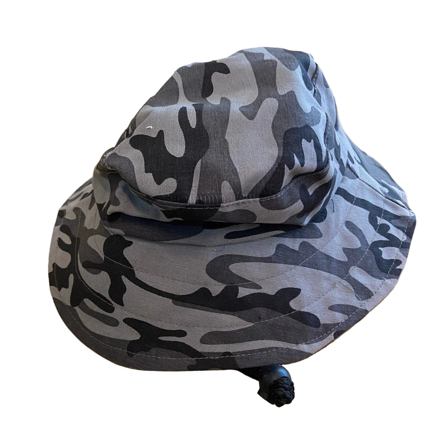 Camouflage-patterned bucket hat on a wooden surface