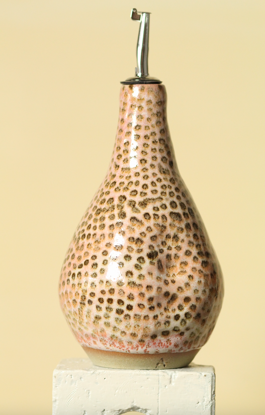 Decorative bottle with leopard print pattern on a beige background
