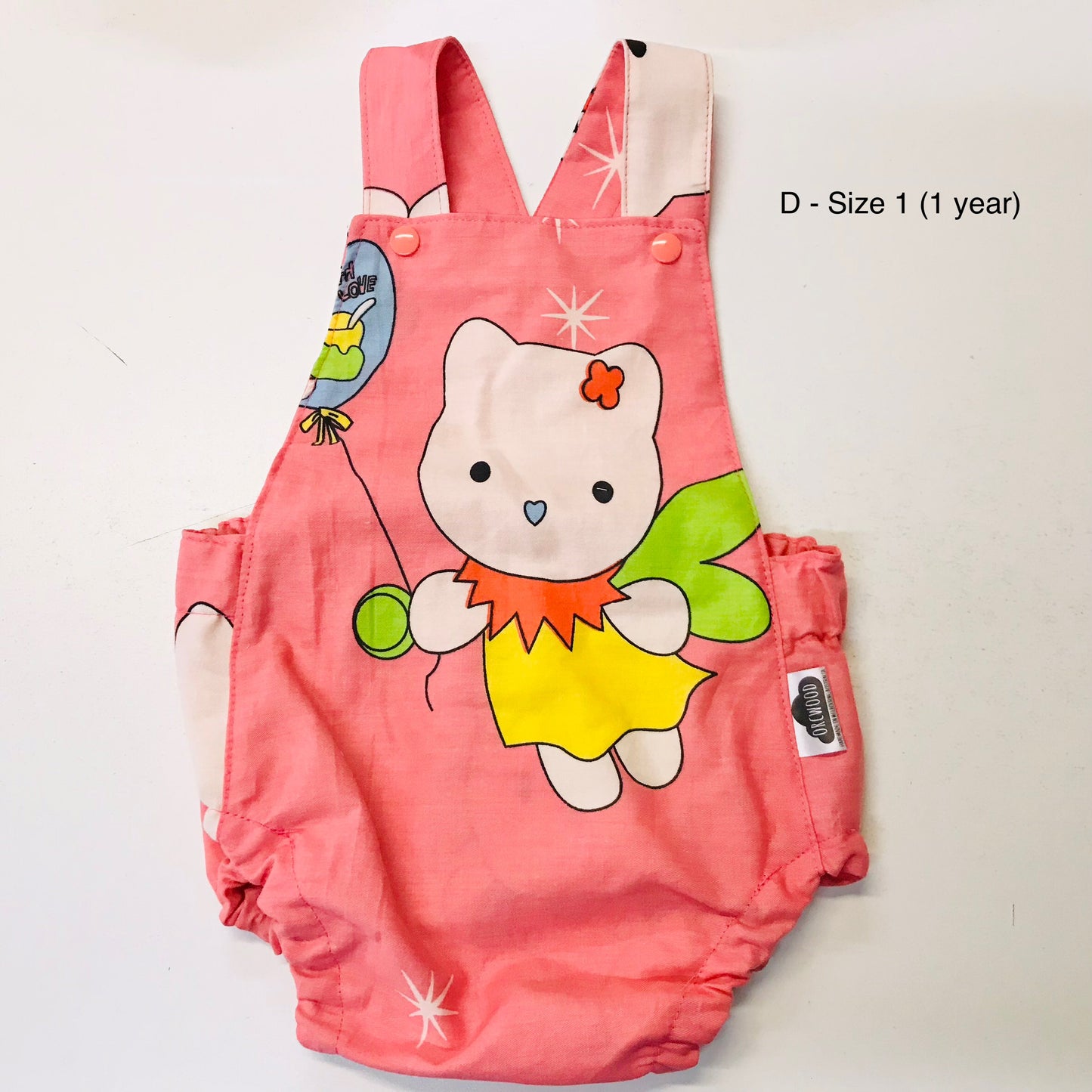 Pink children's romper with cartoon design on a white background
