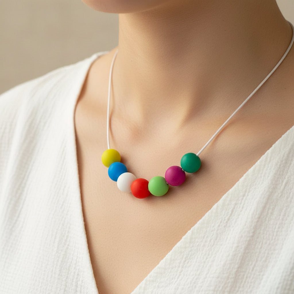 Colorful bead necklace on a beige surface