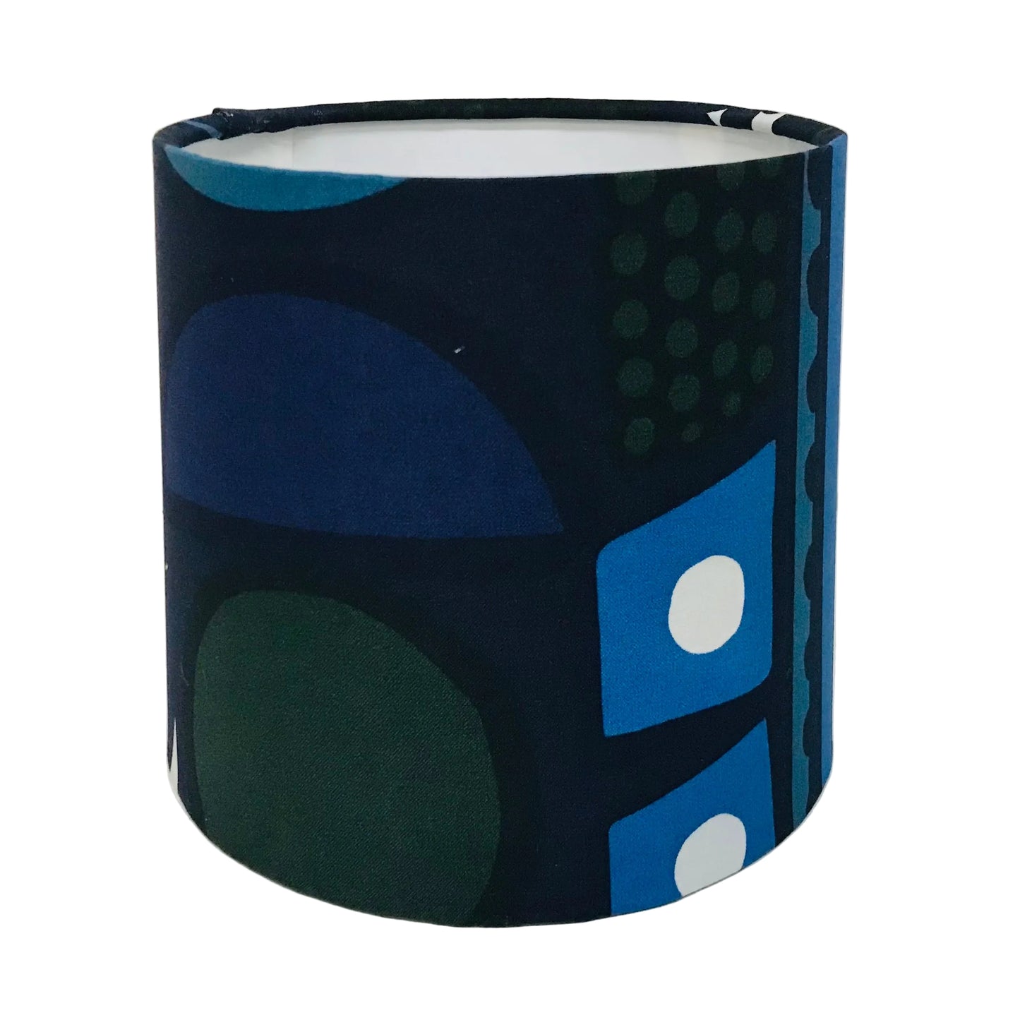 A cylindrical fabric lampshade featuring a mid-century modern abstract geometric pattern in navy, blue, green, and white, photographed against a plain white background.