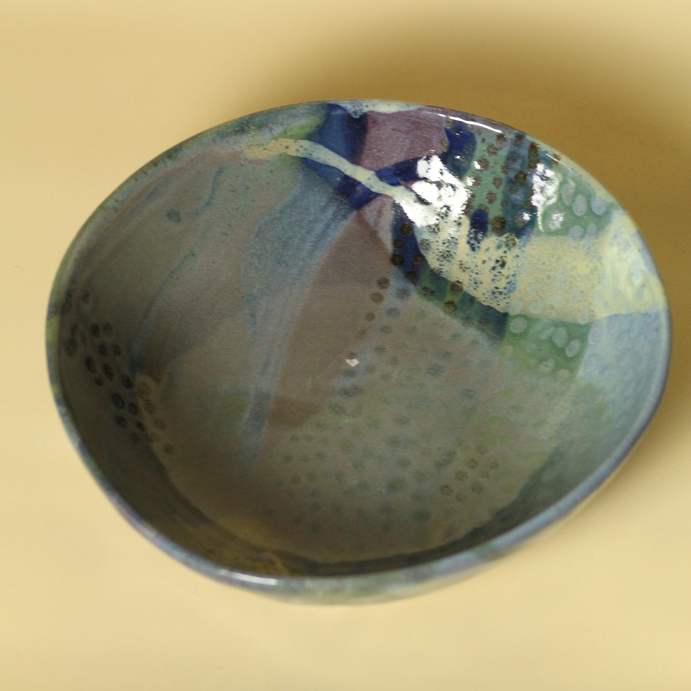 Ceramic bowl with abstract design on a beige background