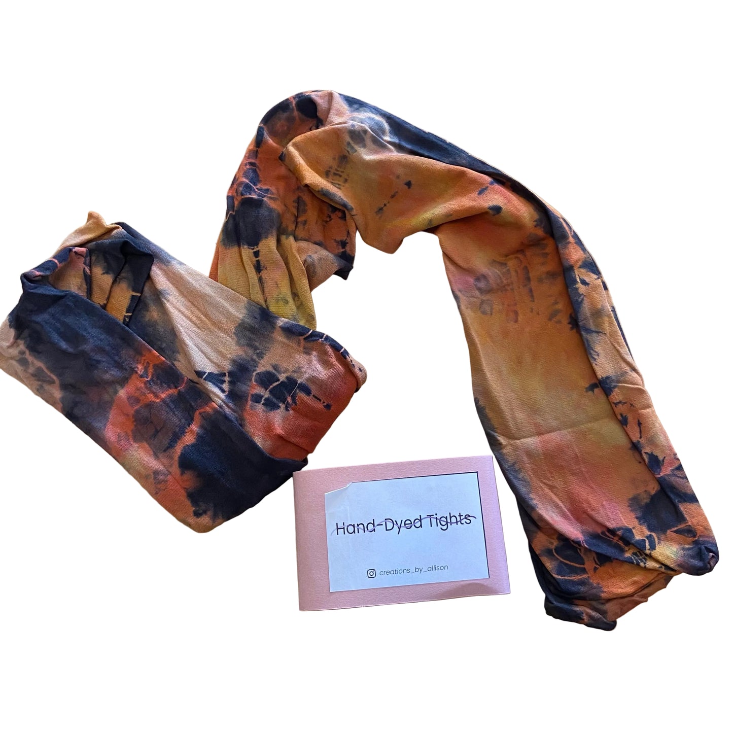 Hand-dyed tights with a label on a wooden surface