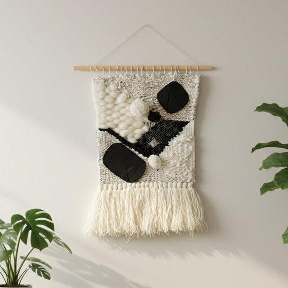 Living room with a wall hanging, plants, and a chair.