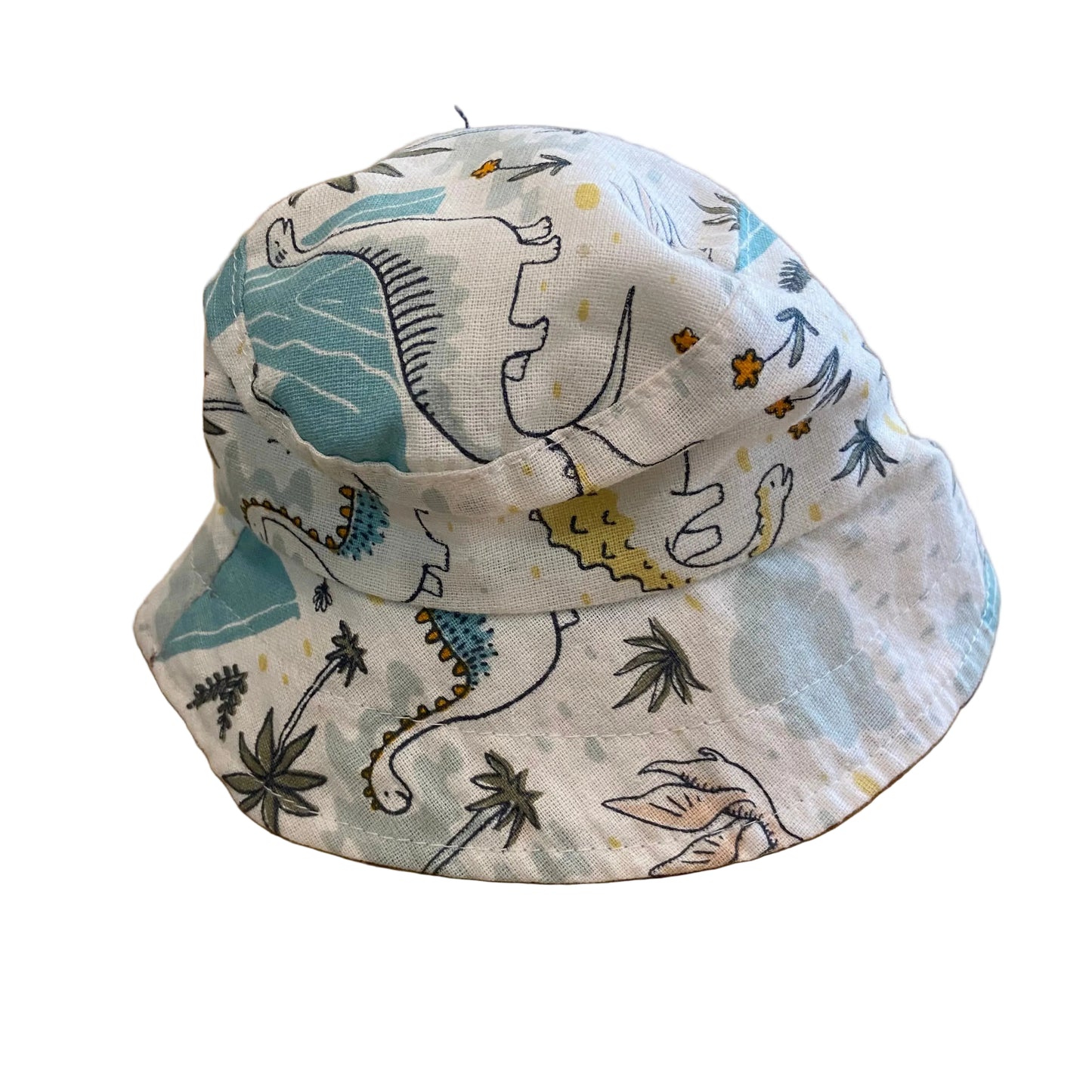 Children's bucket hat with dinosaur pattern on a wooden surface