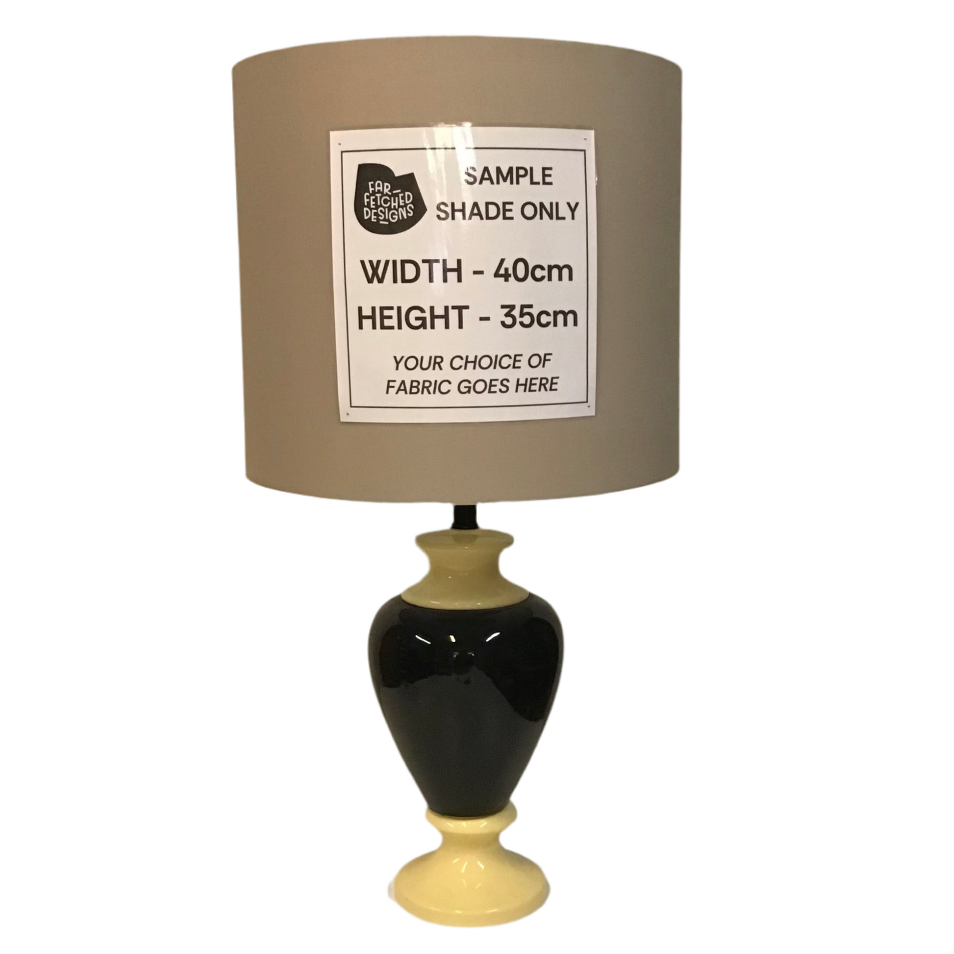 Lamp with a beige shade and black base on a white background